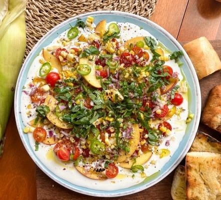 Peach, tomato and corn salad on whipped ricotta