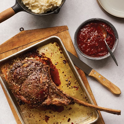 Grilled Tomahawk steak with green peppercorn and BBQ onion relish