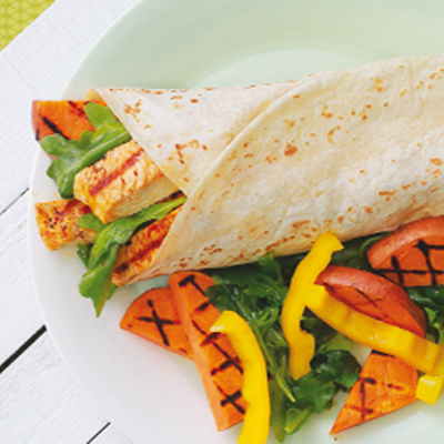 Grilled turkey wrap with hummus, sweet potatoes, lemon and arugula